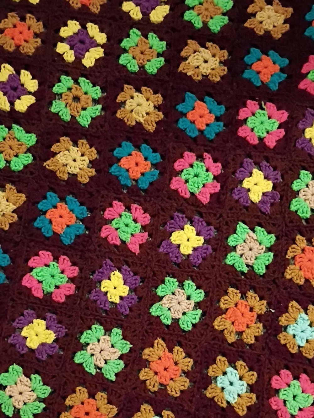 Handmade Multicolor Crochet Granny Square Blanket - Brown Background